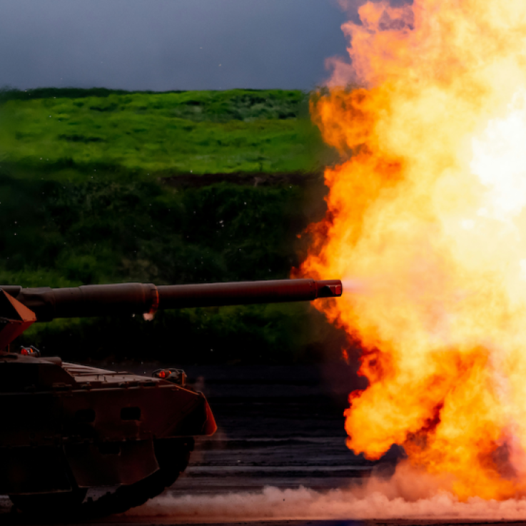 An image of a tank firing. There is a large explosion with lots of flames.